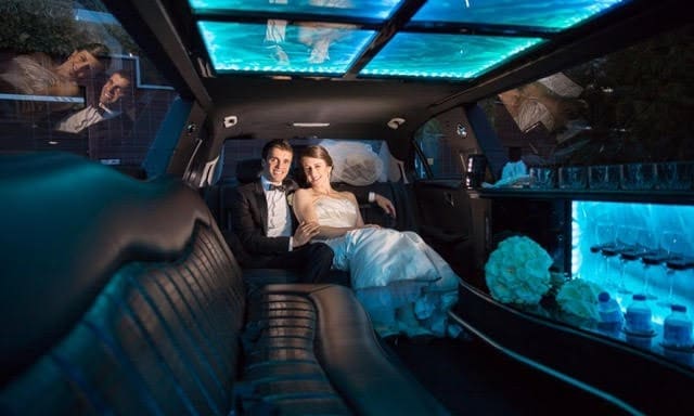 A couple sitting inside a Mercedes Stretch Limousine by Metrowest Limousine Rental in Metrowest