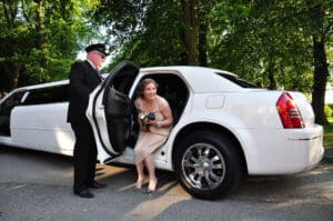 Prom girl coming out of Metrowest Limousines luxury car