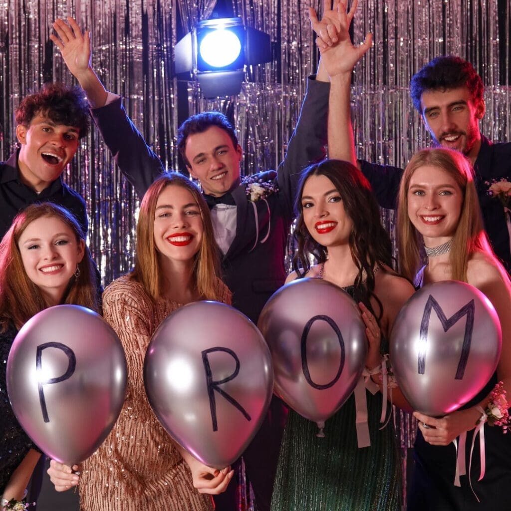 Group of teen agers celebrating prom night and planning to get on party bus for after party in worcester